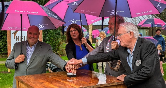 Opening buurtschap De Nieuwe Hoeven Een groep mensen die paraplu's houden