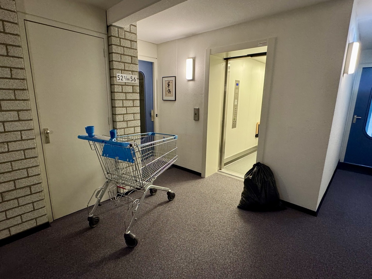 Winkelwagen op de inpandige galerij staat in de weg bij calamiteiten